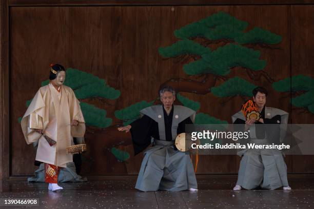 Professional ‘Noh’ drama performs while cherry blossoms are full bloom to celebrate the flower viewing tradition on a traditional outdoor stage at...