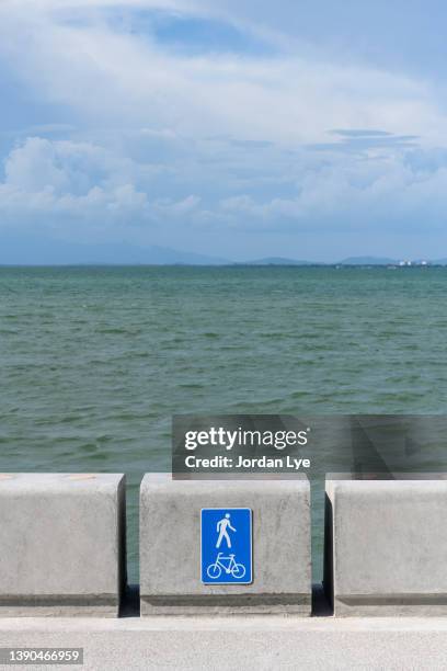 sea barriers with scenic view of sea against clear blue sky - stödjemur bildbanksfoton och bilder