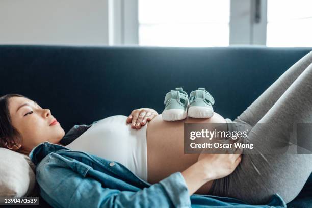 the joy of expecting a baby - chinese baby shoe stock pictures, royalty-free photos & images