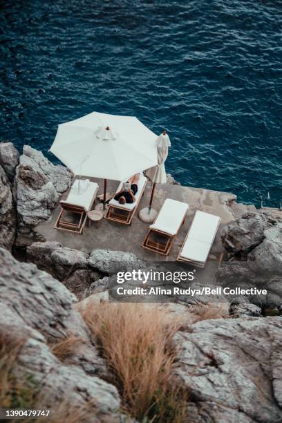 Man relaxing in a long chair by the sea