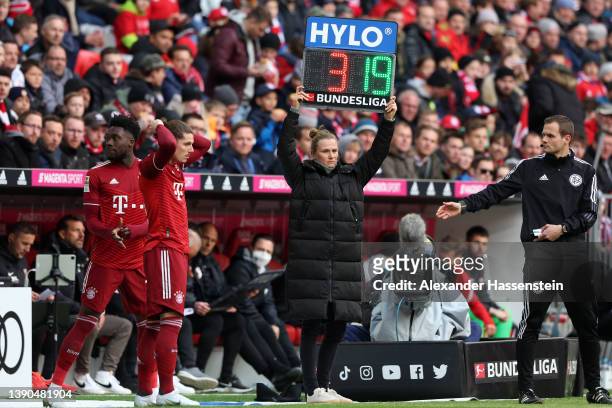 Alphonso Davies and Marcel Sabitzer of FC Bayern Muenchen prepare to come onto the pitch during the Bundesliga match between FC Bayern Muenchen and...