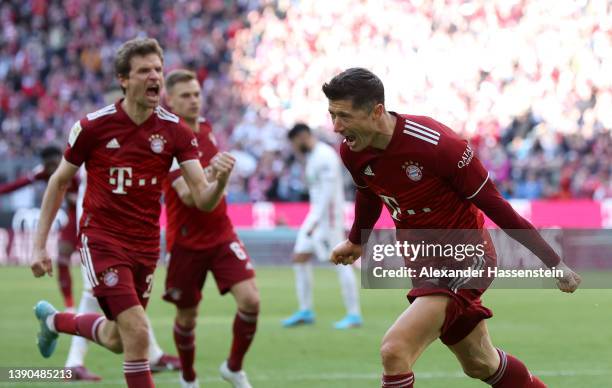 Robert Lewandowski of FC Bayern Muenchen celebrates after scoring their side's first goal from a penalty during the Bundesliga match between FC...