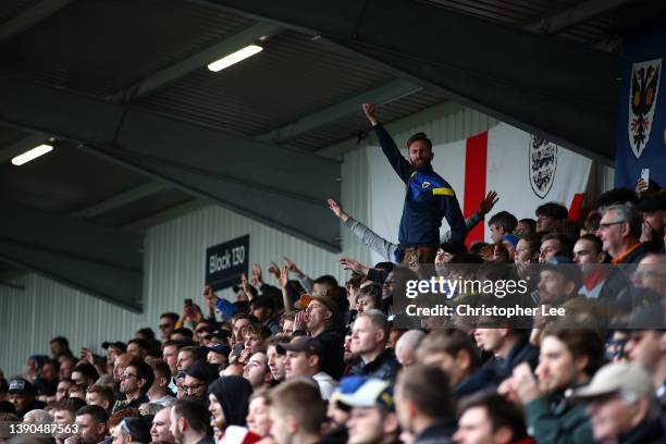 Wimbledon fans celebrate in the stands during the Sky Bet League One match between AFC Wimbledon and Milton Keynes Dons at Plough Lane on April 09,...