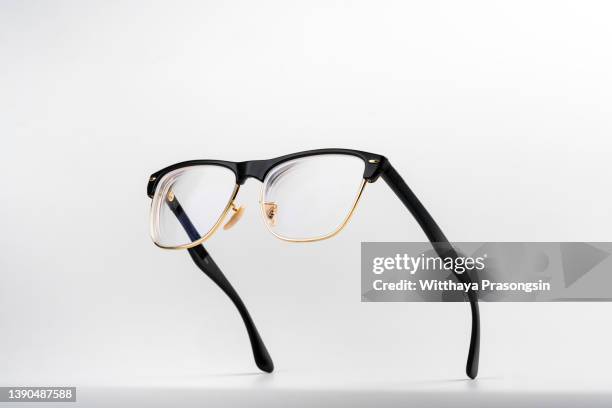 studio shot of flying black glasses - horn rimmed glasses stock pictures, royalty-free photos & images