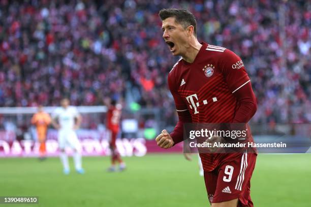 Robert Lewandowski of FC Bayern Muenchen celebrates after scoring their side's first goal from a penalty during the Bundesliga match between FC...