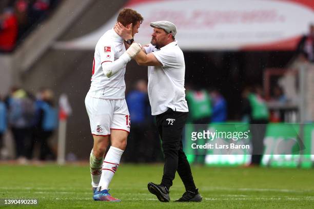 Steffen Baumgart embraces Luca Kilian of 1.FC Koeln after their sides victory during the Bundesliga match between 1. FC Koeln and 1. FSV Mainz 05 at...