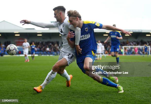 Daniel Harvie of Milton Keynes Dons battles for possession with Jack Rudoni of AFC Wimbledon during the Sky Bet League One match between AFC...