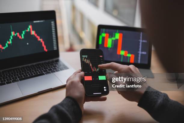 investors are trading stocks with smartphone. in the electronic market through computer, tablet and smartphone. - graphic accident photos stock pictures, royalty-free photos & images