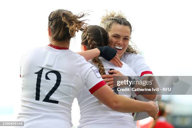 Ellie Kildunne and Helena Rowland celebrate with Jess Breach of England after scoring their sides third try during the TikTok Women's Six Nations...