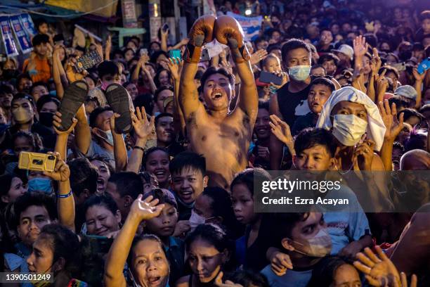 People cheer as senator and boxing icon Manny Pacquiao takes part in a rally in a slum area as he campaigns for the presidency on April 09, 2022 in...