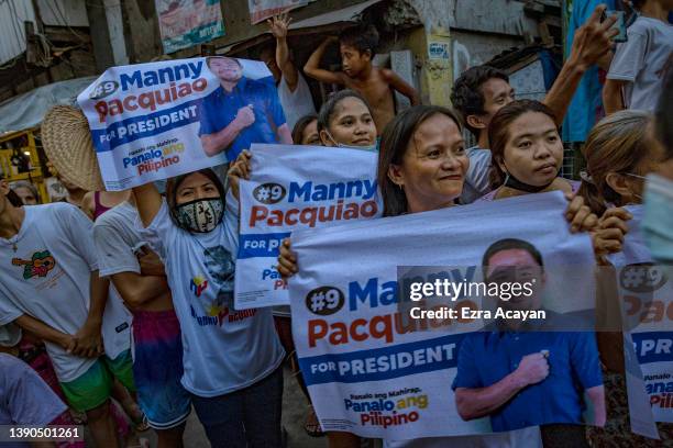 People cheer as senator and boxing icon Manny Pacquiao takes part in a rally in a slum area as he campaigns for the presidency on April 09, 2022 in...