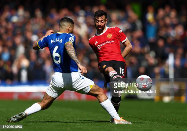 Bruno Fernandes of Manchester United passes the ball as Allan of Everton looks on during the Premier League match between Everton and Manchester...