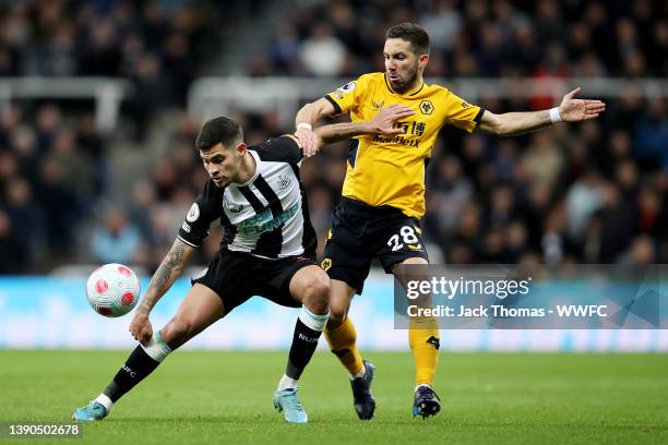 Bruno Guimaraes of Newcastle United is challenged by Joao Moutinho of Wolverhampton Wanderers during the Premier League match between Newcastle...