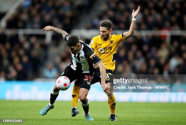 Bruno Guimaraes of Newcastle United is challenged by Joao Moutinho of Wolverhampton Wanderers during the Premier League match between Newcastle...