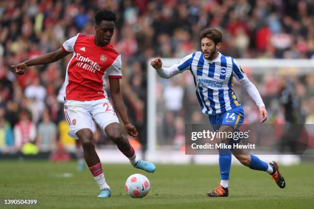 Albert Sambi Lokonga of Arsenal is challenged by Adam Lallana of Brighton & Hove Albion during the Premier League match between Arsenal and Brighton...