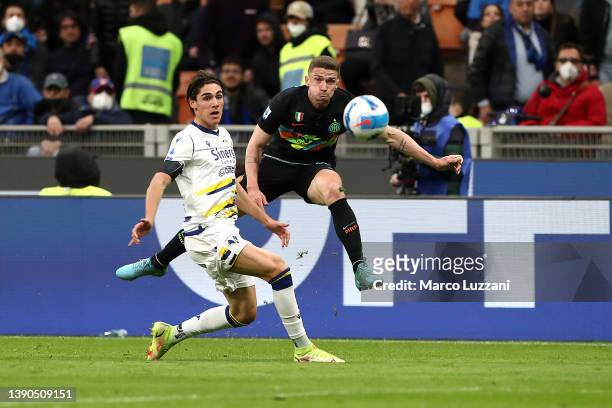 Robin Gosens of FC Internazionale is challenged by Matteo Cancellieri of Hellas Verona during the Serie A match between FC Internazionale and Hellas...