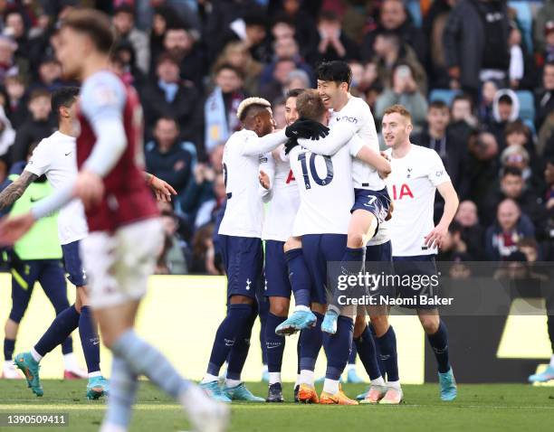 Heung-Min Son of Tottenham Hotspur celebrates after scoring their side's third goal with team mates during the Premier League match between Aston...