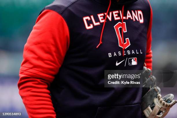 Cleveland Guardians new logo appears on a coaches sweatshirt before the game against the Kansas City Royals on Opening Day at Kauffman Stadium on...
