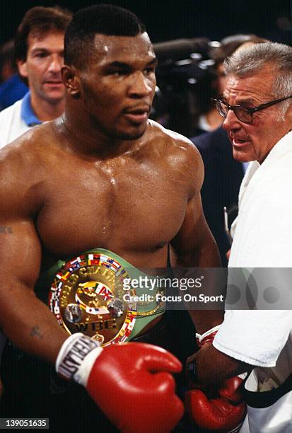Heavyweight fighter Mike Tyson wears the WBC title belt after defeating Trevor Berbick by TKO in the second round of a scheduled twelve round WBC...