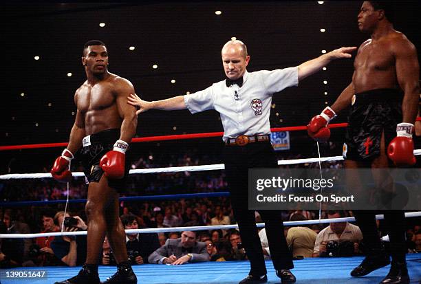 Heavyweights Mike Tyson, left, and Trevor Berbick, right, is separated by referee Mills Lane during a scheduled twelve round WBC heavyweight title...