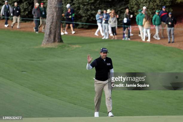Charl Schwartzel of South Africa waves to the crowd after making eagle on the 10th hole during the third round of the Masters at Augusta National...