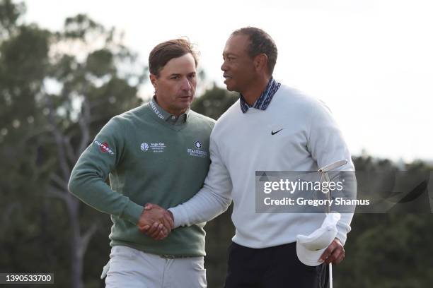 Kevin Kisner and Tiger Woods shake hands on the 18th green after finishing their round during the third round of the Masters at Augusta National Golf...