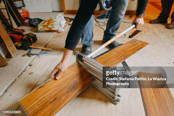 vinyl planks cutter in use - flooring contractor stock pictures, royalty-free photos & images