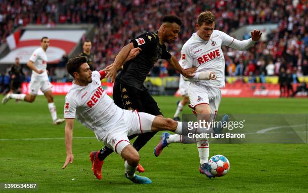 Jonas Hector of Koeln challenges Karim Onisiwo of Mainz during the Bundesliga match between 1. FC Köln and 1. FSV Mainz 05 at RheinEnergieStadion on...
