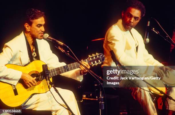 Brazilian singer-composers and activists Caetano Veloso , on acoustic guitar, and Gilberto Gil, on percussion, perform at a JVC Jazz Festival concert...