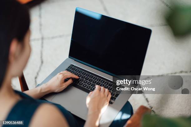 woman using laptop in office - over shoulder stock-fotos und bilder