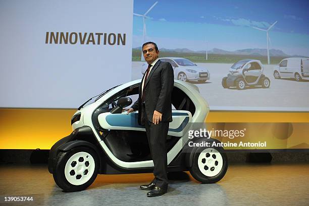 Carlos Ghosn, chief executive officer of Renault, poses next to a Renault Twizy electric car after a news conference on February 16, 2012 in Paris,...