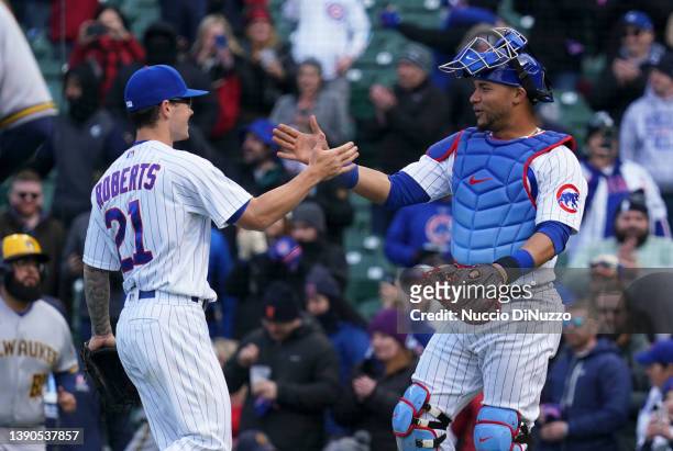 Ethan Roberts and Willson Contreras of the Chicago Cubs celebrate their team win over the Milwaukee Brewers at Wrigley Field on April 09, 2022 in...