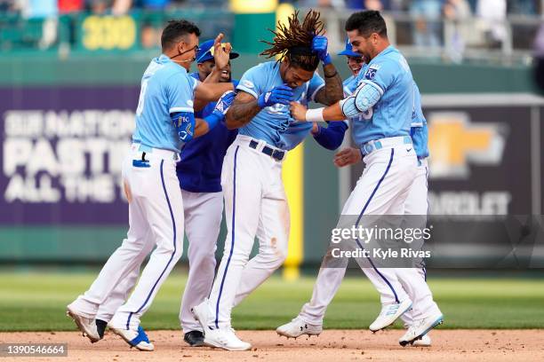 Adalberto Mondesi of the Kansas City Royals celebrates with teammates after hitting the game winning single scoring Kyle Isbel from third base...