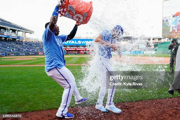 Salvador Perez of the Kansas City Royals douses Collin Snider with water after defeating the Cleveland Guardians in 10 innings at Kauffman Stadium on...