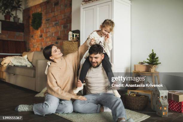 happy family having fun at home on the eve of new years and christmas holidays. - happy holidays family stock pictures, royalty-free photos & images