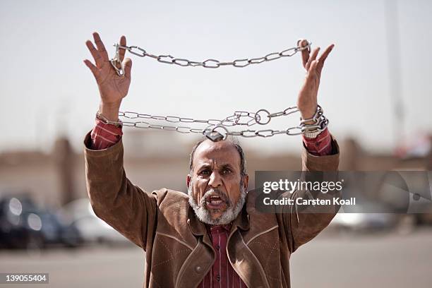 Protester holds up a symbolic chain as the trial of ousted Egyptian president Hosni Mubarak continues on February 16, 2012 in Cairo, Egypt. The...