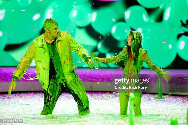 Rob Gronkowski and Miranda Cosgrove are slimed onstage during the Nickelodeon's Kids' Choice Awards 2022 at Barker Hangar on April 09, 2022 in Santa...