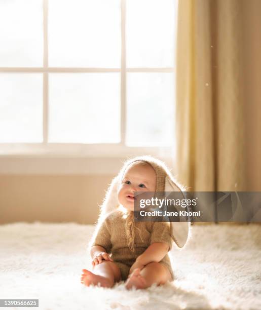 infant in bunny costume - tierkostüm stock-fotos und bilder