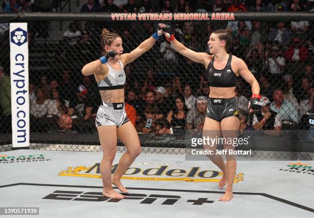 Tecia Torres and Mackenzie Dern react after their strawweight fight during the UFC 273 event at VyStar Veterans Memorial Arena on April 09, 2022 in...