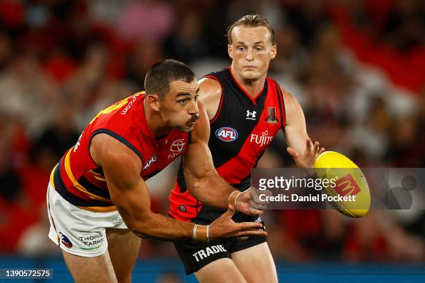 Taylor Walker of the Crows handballs during the round four AFL match between the Essendon Bombers and the Adelaide Crows at Marvel Stadium on April...