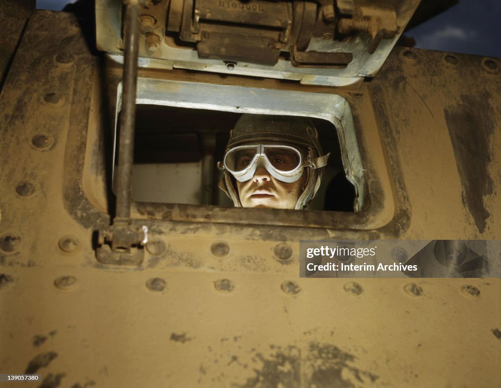 Portrait of a tank driver, peeking through the M-3 tank's window, in ...