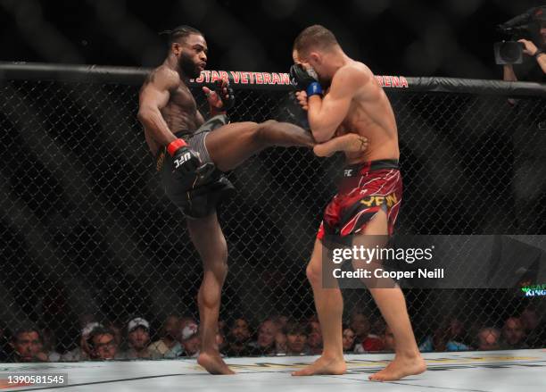 Aljamain Sterling kicks Petr Yan of Russia in their UFC bantamweight championship fight during the UFC 273 event at VyStar Veterans Memorial Arena on...