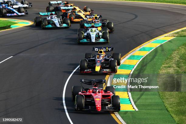 Charles Leclerc of Monaco driving the Ferrari F1-75 leads Max Verstappen of the Netherlands driving the Oracle Red Bull Racing RB18 and the rest of...