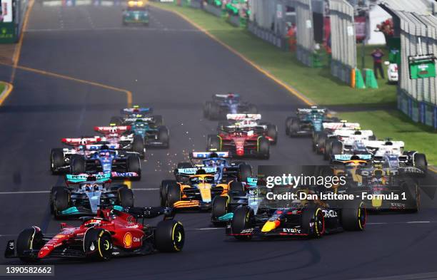 Charles Leclerc of Monaco driving the Ferrari F1-75 leads Max Verstappen of the Netherlands driving the Oracle Red Bull Racing RB18 and the rest of...