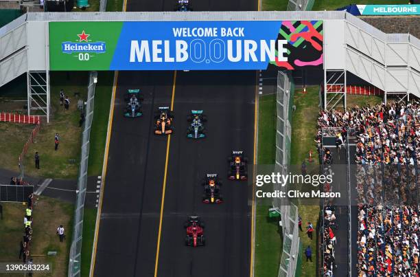 Charles Leclerc of Monaco driving the Ferrari F1-75 leads Max Verstappen of the Netherlands driving the Oracle Red Bull Racing RB18, Sergio Perez of...