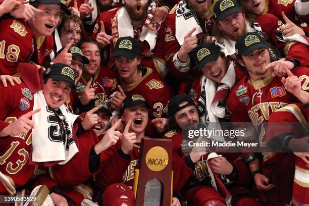 The Denver Pioneers celebrate after defeating the Minnesota State Mavericks 5-1 in the 2022 NCAA Division I Man's Ice Hockey Championship game at TD...