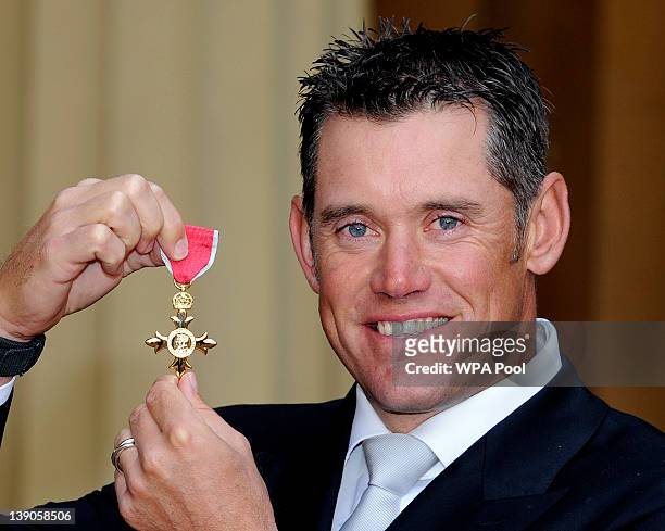 Golfer Lee Westwood smiles after he received his Officer of the British Empire medal from Queen Elizabeth II during an Investiture ceremony at...