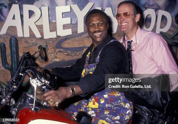 Joe Frazier and Peter Fonda attend the grand opening of the Harley-Davidson Cafe on October 19, 1993 in New York City.