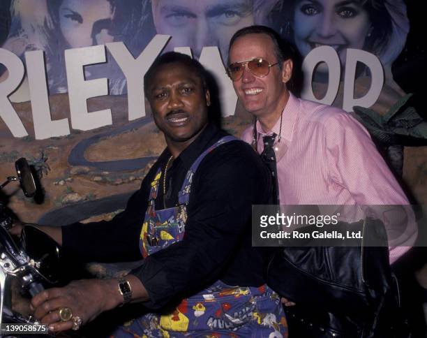 Joe Frazier and Peter Fonda attend the grand opening of the Harley-Davidson Cafe on October 19, 1993 in New York City.