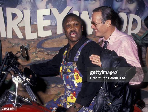 Joe Frazier and Peter Fonda attend the grand opening of the Harley-Davidson Cafe on October 19, 1993 in New York City.